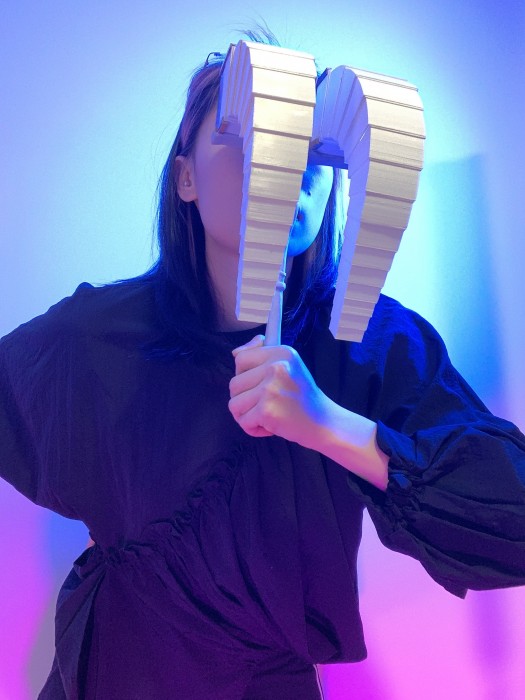 A woman wearing jewellery which covers her eyes