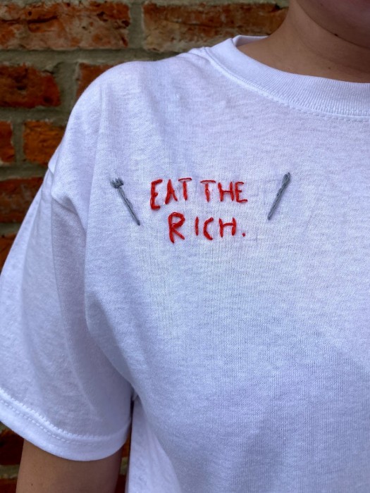 Embroidered lettering 'Eat the Rich' on a white T-shirt