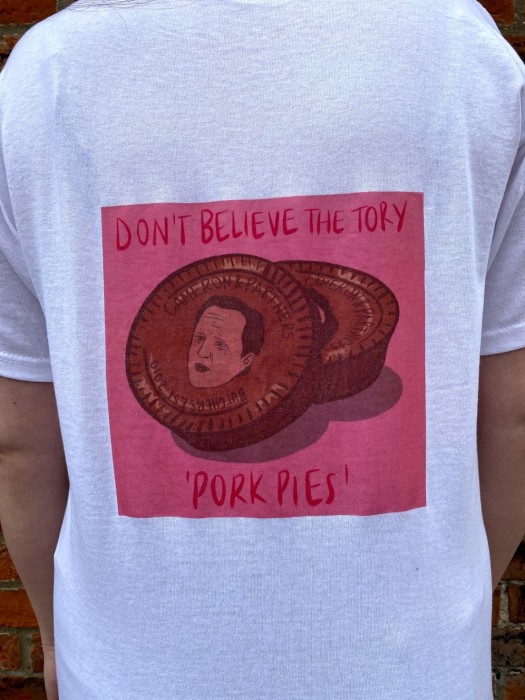 A T-shirt with a pink political design printed in ink.