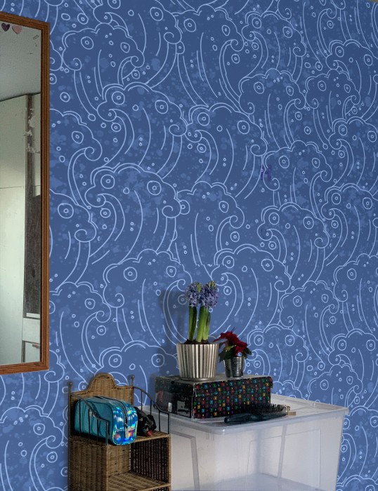 A photo of a blue wave wallpaper decorating a wall.