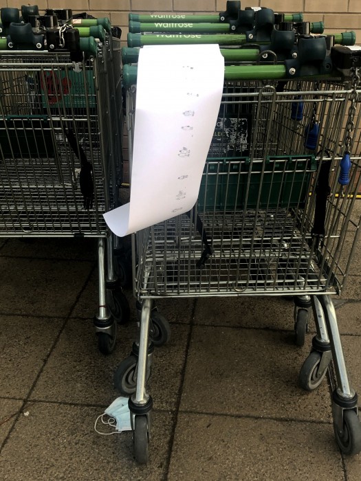 A photograph of the work laid across a shopping trolley.