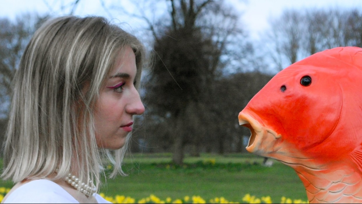 A photo of a woman and a fish head