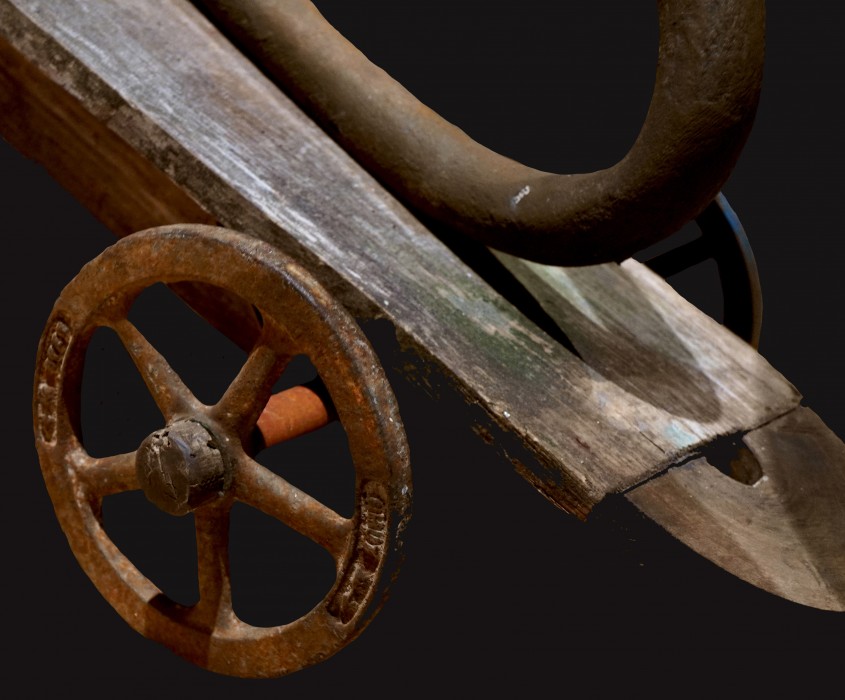 A close up image of a chariot sculpture wheel