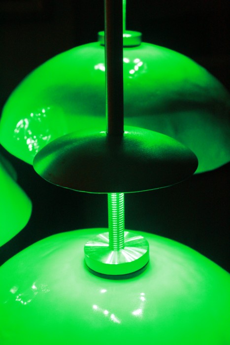 Close detail of LED backplate illuminating porcelain lobe with green light.