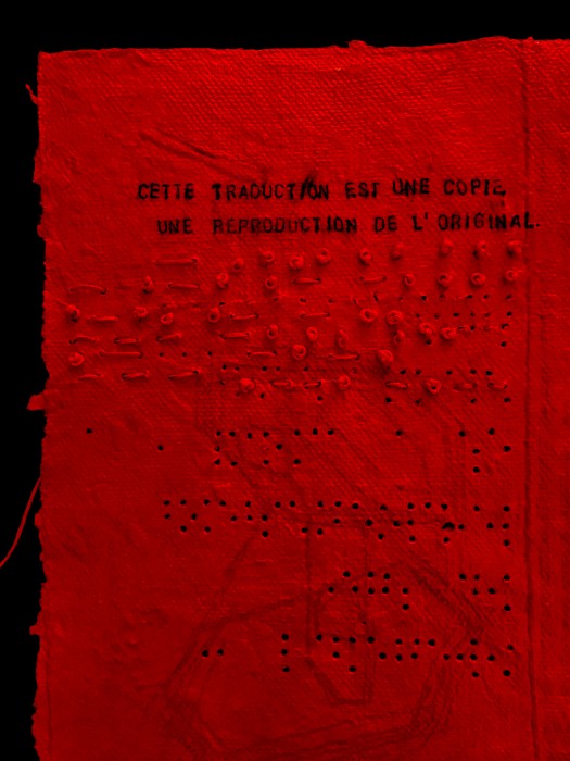 Text on red paper with translations in French, English, Morse code and Braille