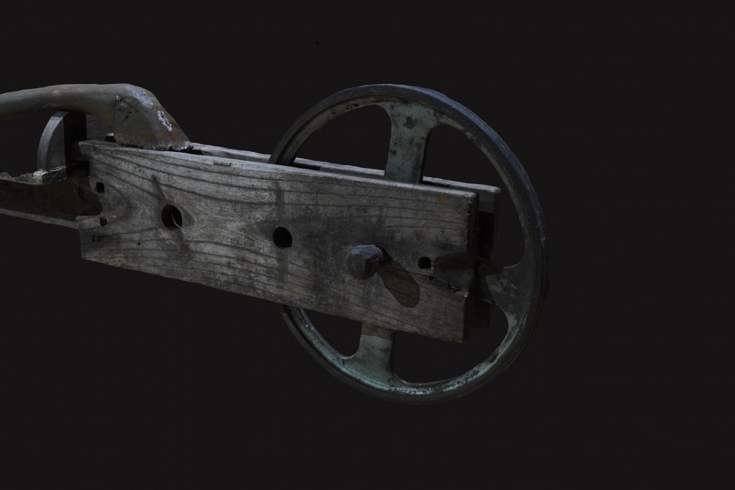 A close up image of a chariot sculpture wheel