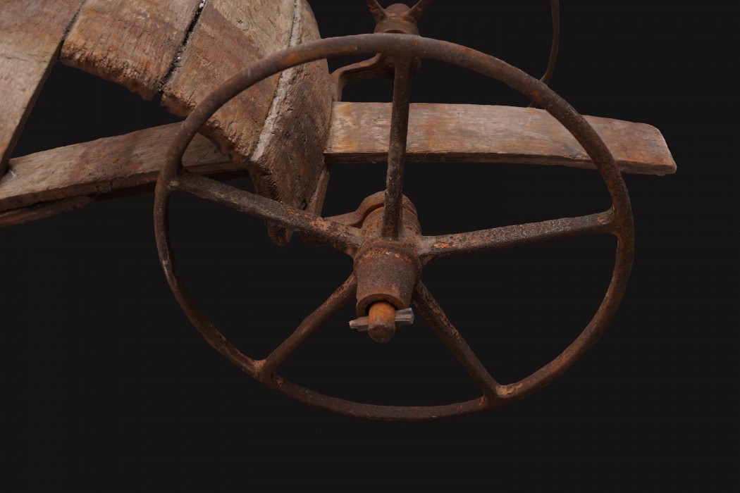 A close up image of a chariot sculpture wheel
