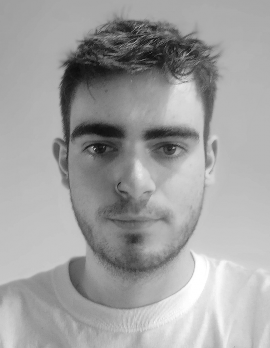 Black and white image of man wearing white t-shirt with nose ring