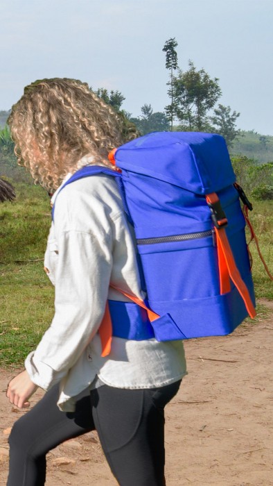 Person carrying a blue rucksack