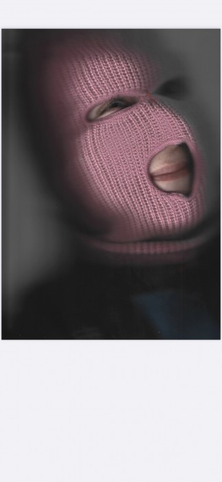 blurry image of a woman's face covered by a pink balaclava