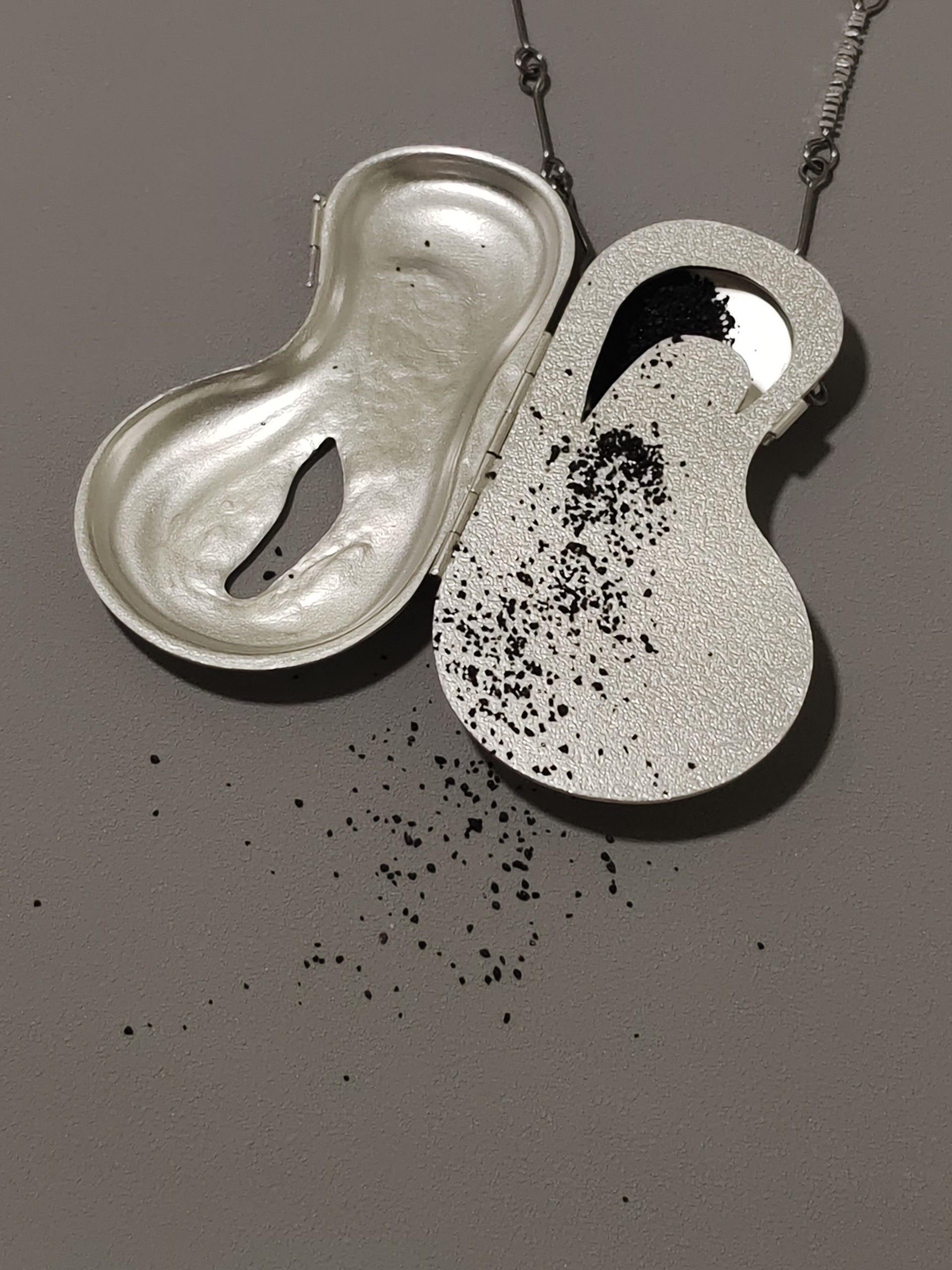 Iceberg Memories Locket, 2024. silver, steel, sand
